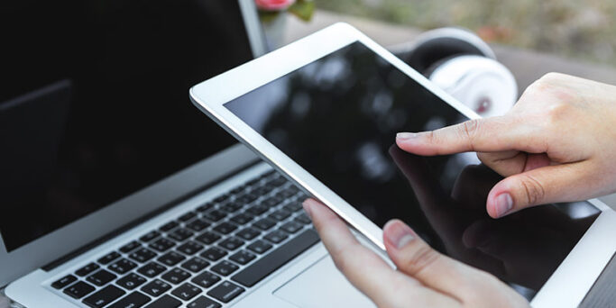 Woman hand hold white tablet with blank empty screen