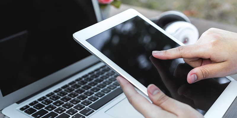 Woman hand hold white tablet with blank empty screen